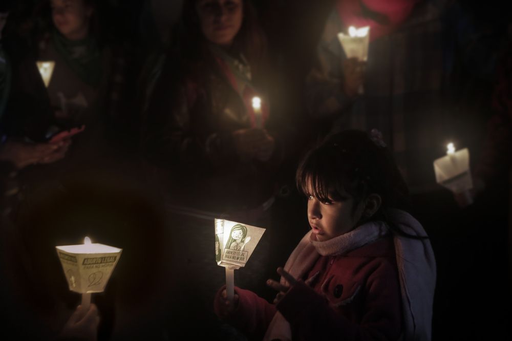 A child holds up a candle