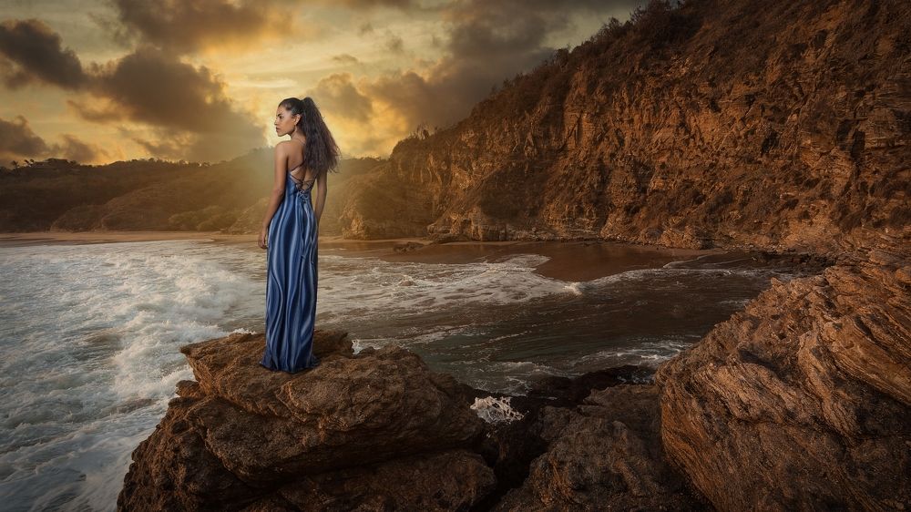 Girl on a rock in the evening light.