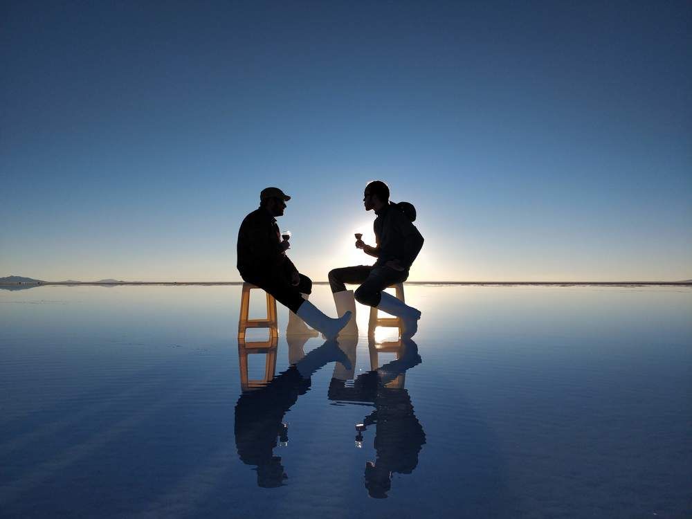 Two friends sitting on a mirror