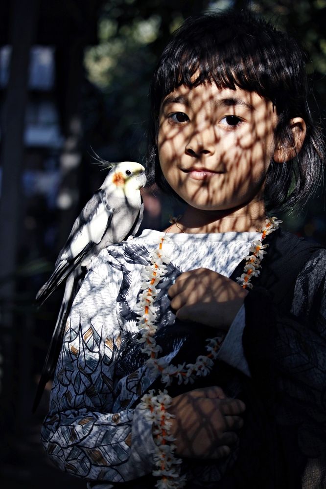 Girl with cockatoo bird