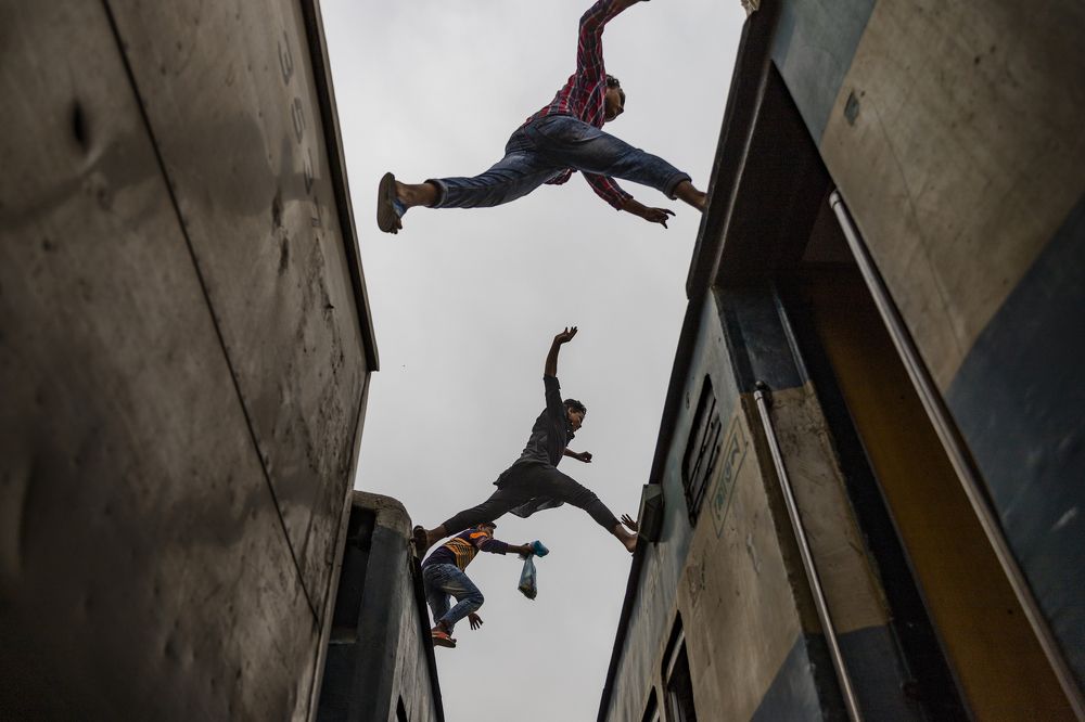 Boys jumping from one train