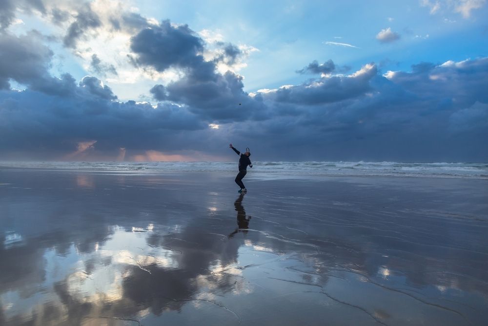 Sport man on the beach with a racket. Gaza - Palestine.