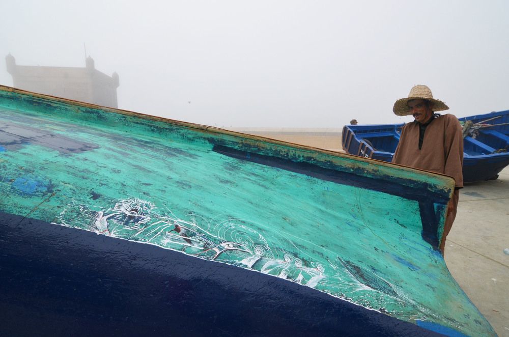 Fisherman's portrait with ephemeral art on a boat