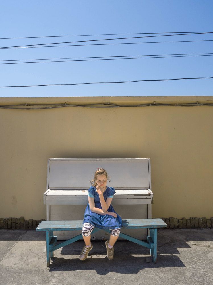 Autistic girl in the old courtyard