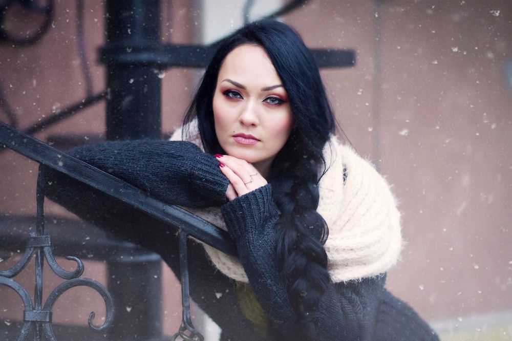 Girl with a scythe in the winter morning.