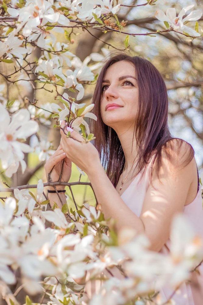 girl in the blooming magnolia garden