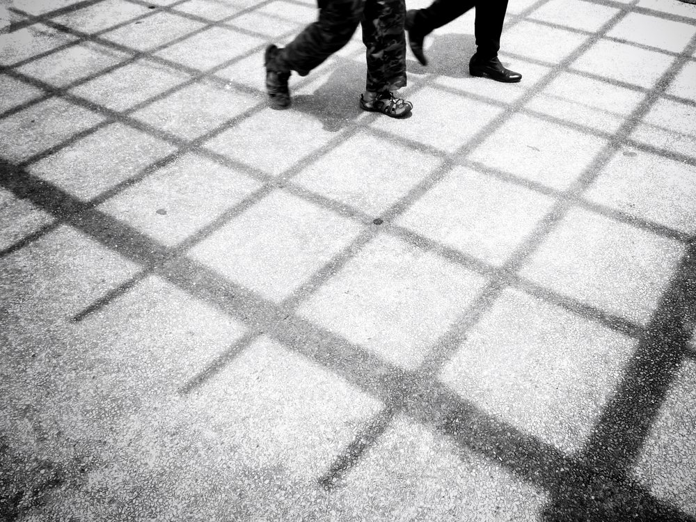 footsteps in the shadow of the bars