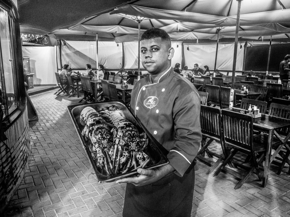 Garcon serving lobster