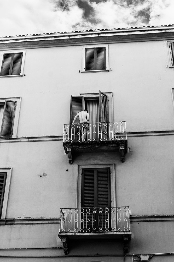 Young man on balcony.