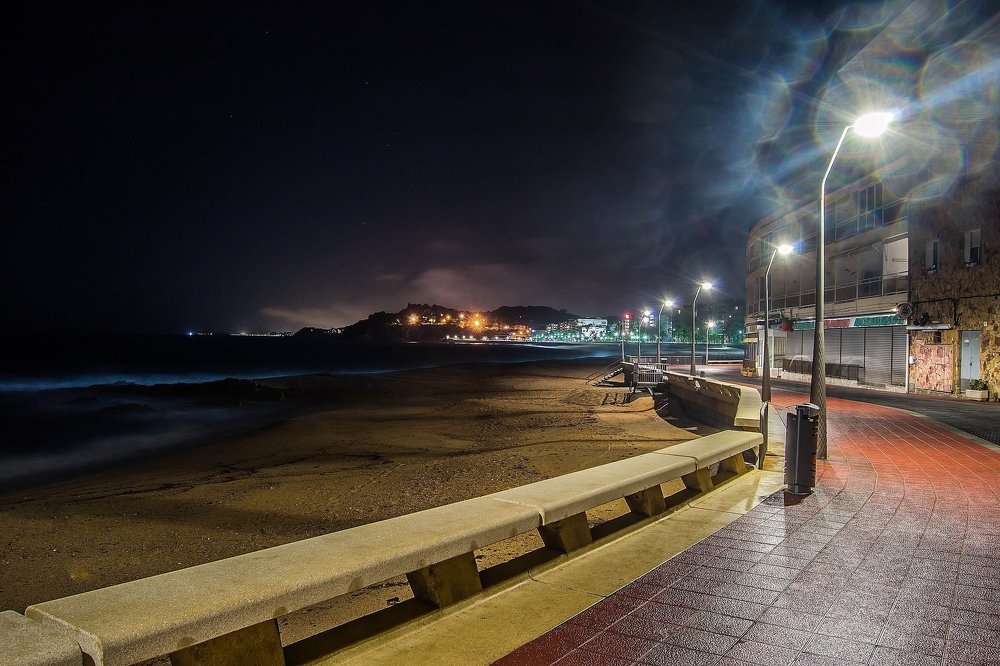 the coast lit by streetlights
