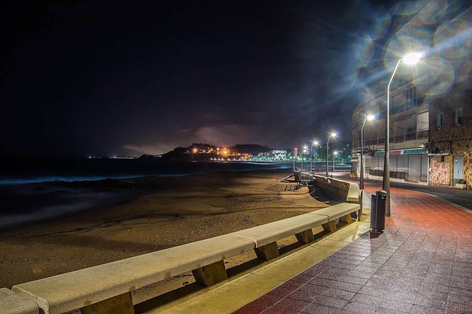 the coast lit by streetlights