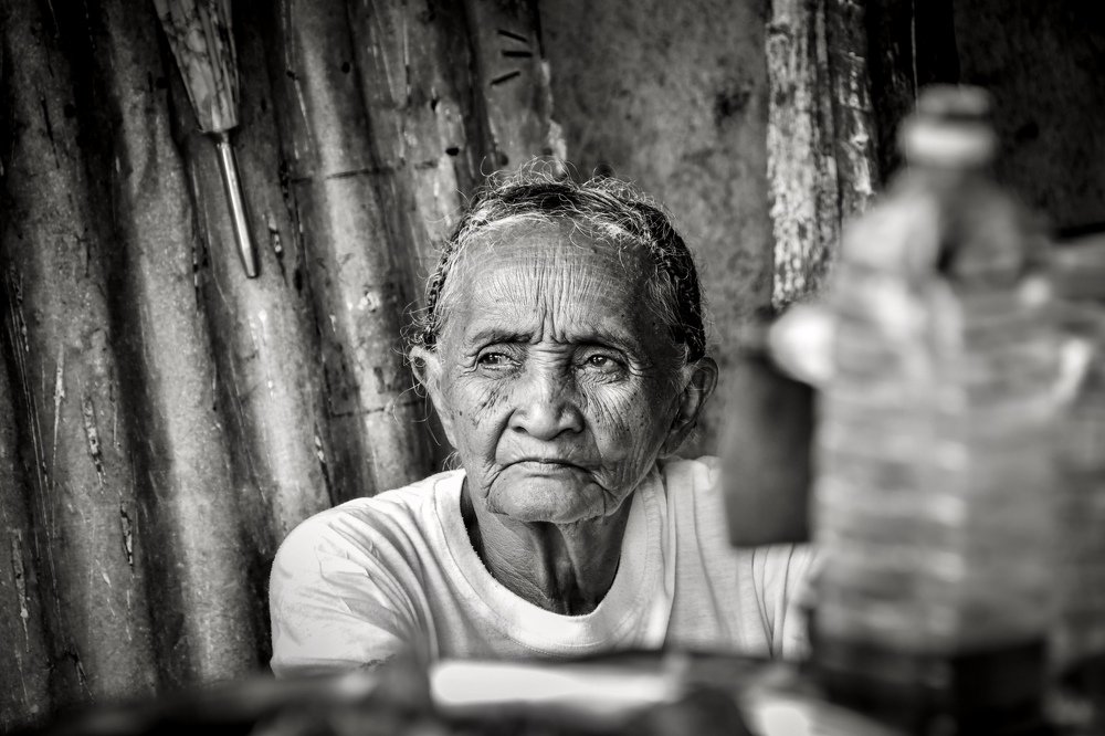 Old woman sitting in a shop