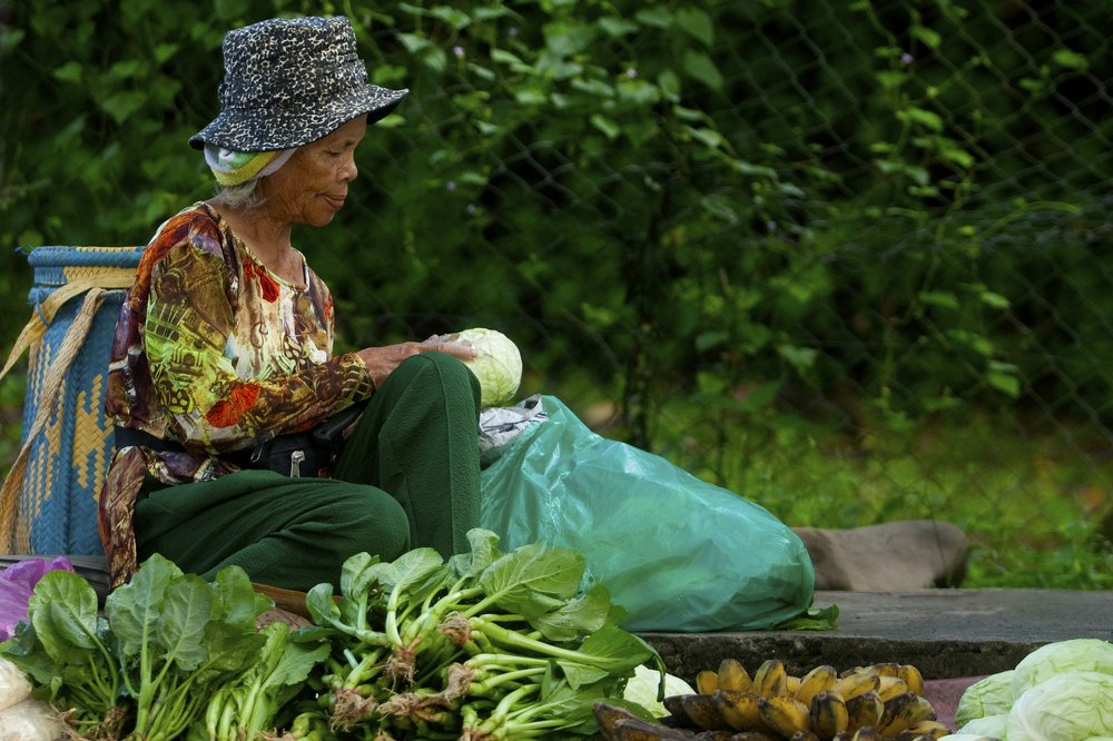 women selling vegetables and tropical fruits.