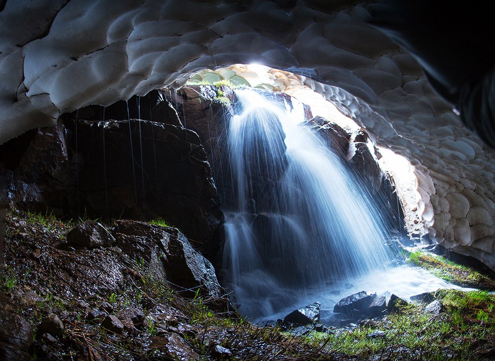 waterfall into snowy cave