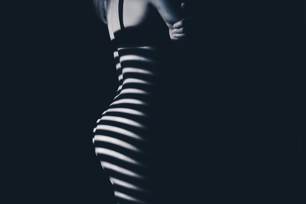 Beautiful body girl in the white line on a black background.