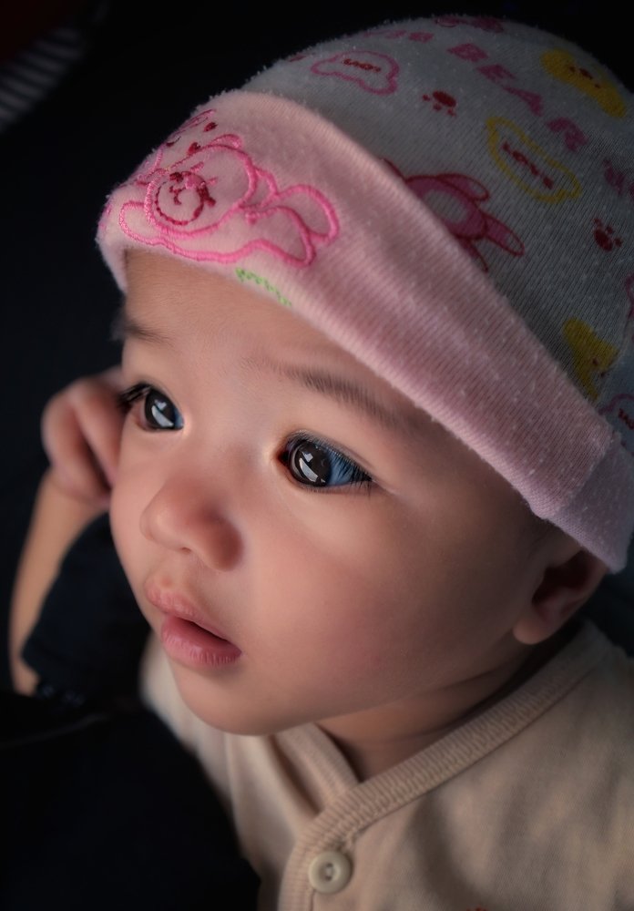 A baby girl staring at the window