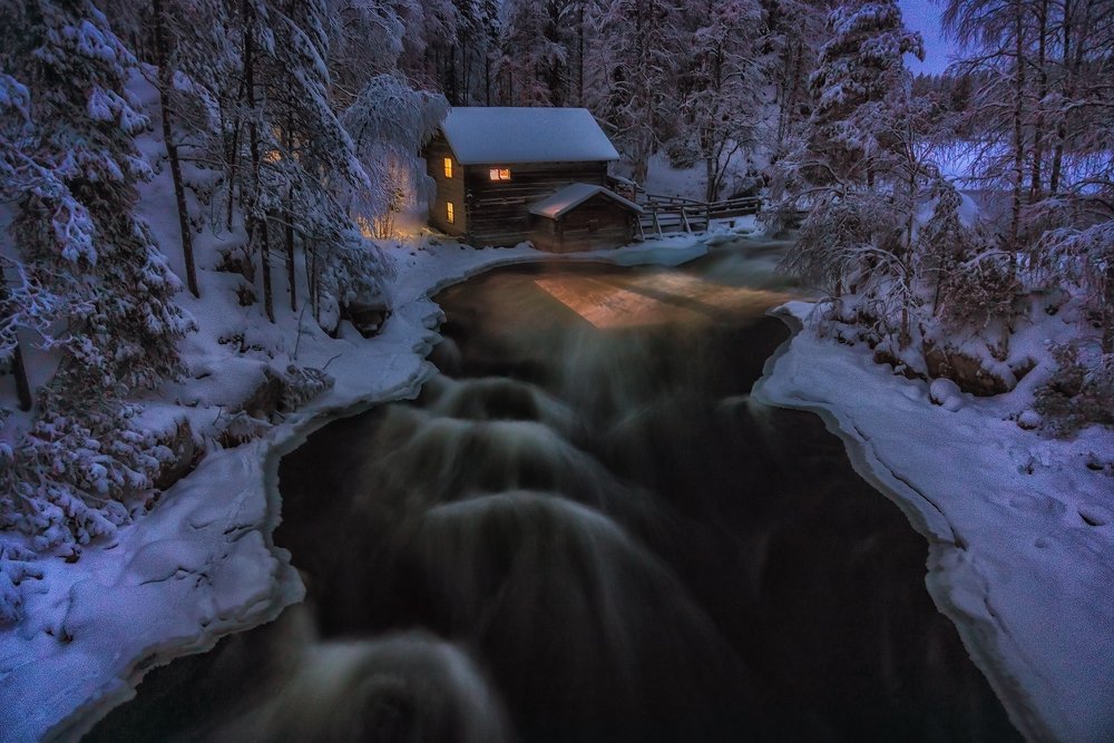 Lonely abandoned house on the Bank of a fast river.