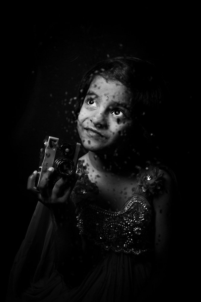 Little girl with antique camera