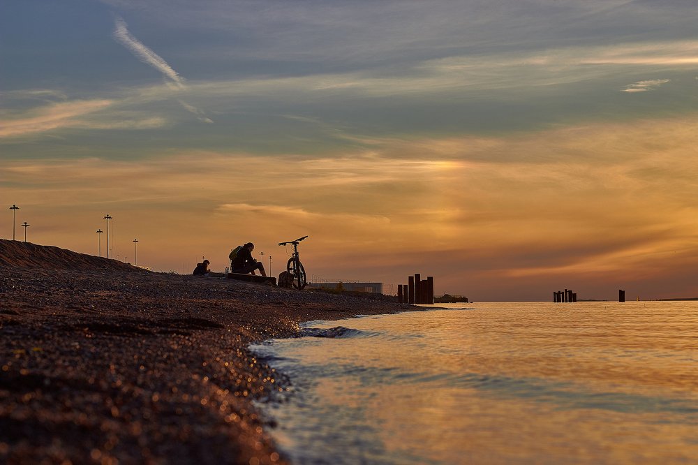 A lone cyclist at sunset