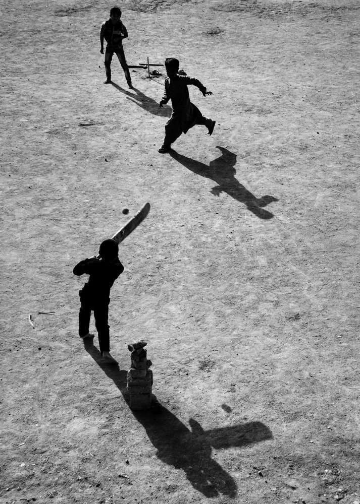 Children from Pakistan play cricket in one of the squares in the city of Najaf in Iraq