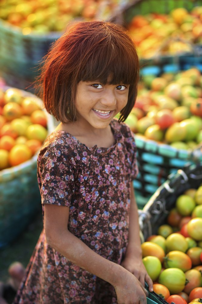 Her smile is more beautyfull than those tomatoes