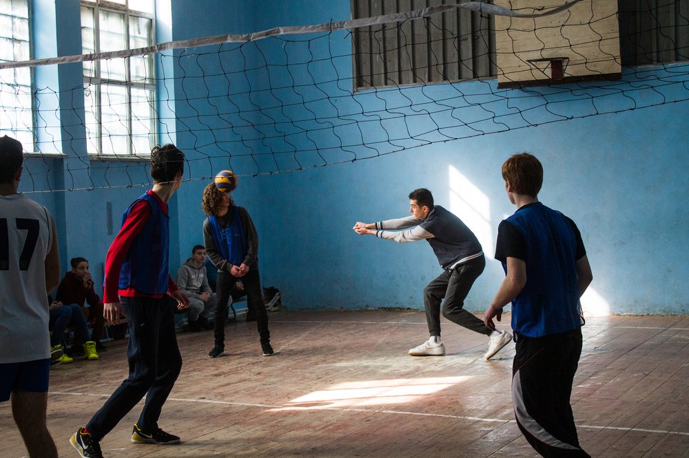 Boys and girls playing volleyball