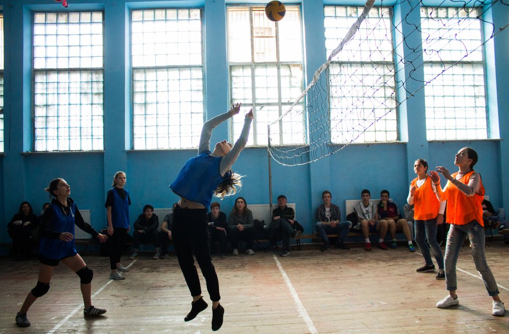 Boys and girls playing volleyball