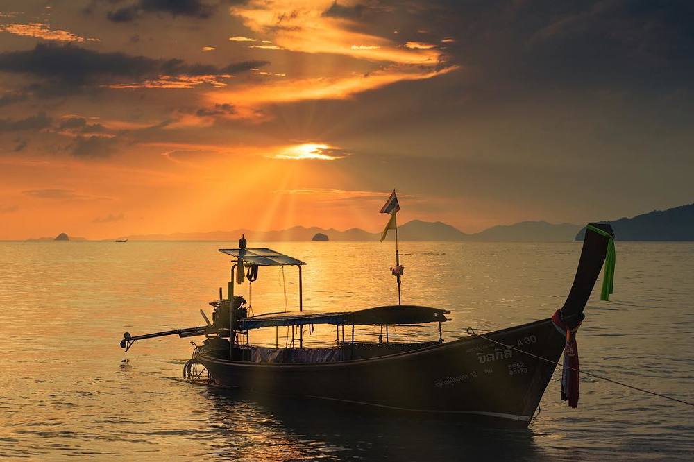 Moored longtail boat at sunset