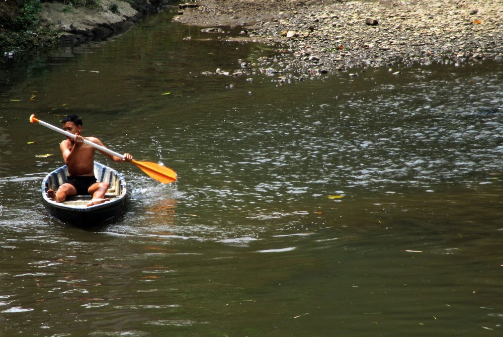 A Child playing a boat