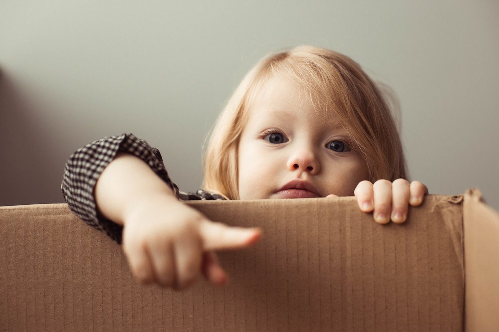 Little girl in a cardboard box