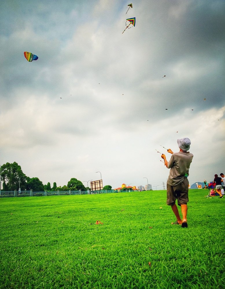 old man is playing a kite