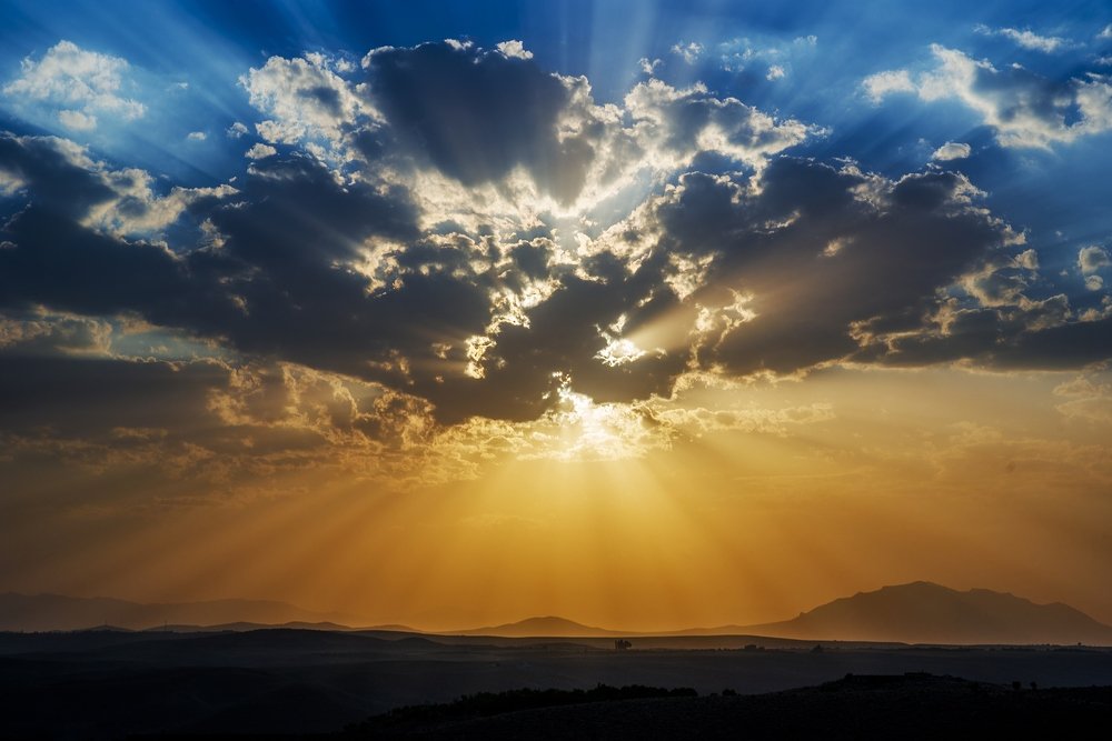 The sunset behind the clouds