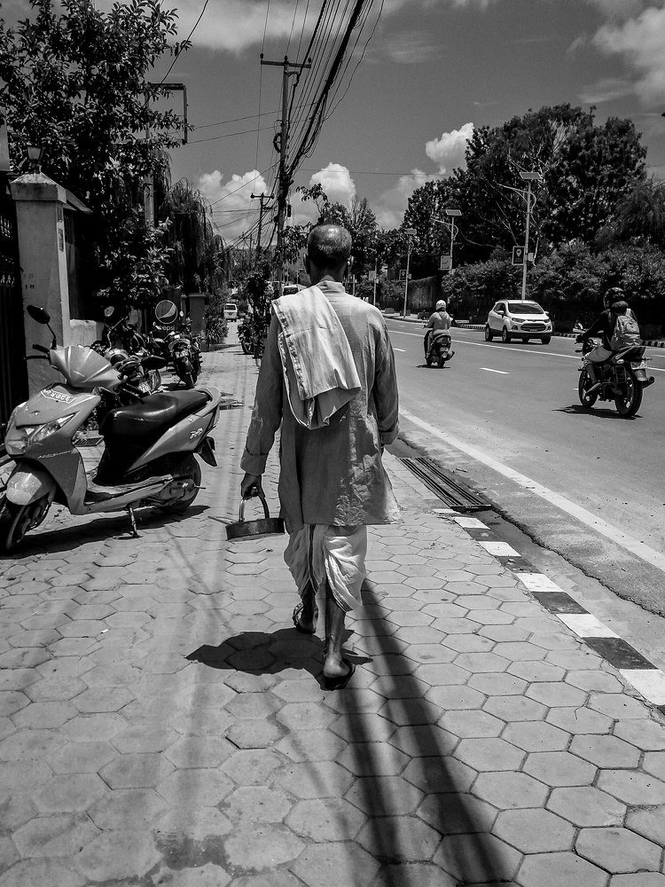Old man walking on the street of kathmandu.