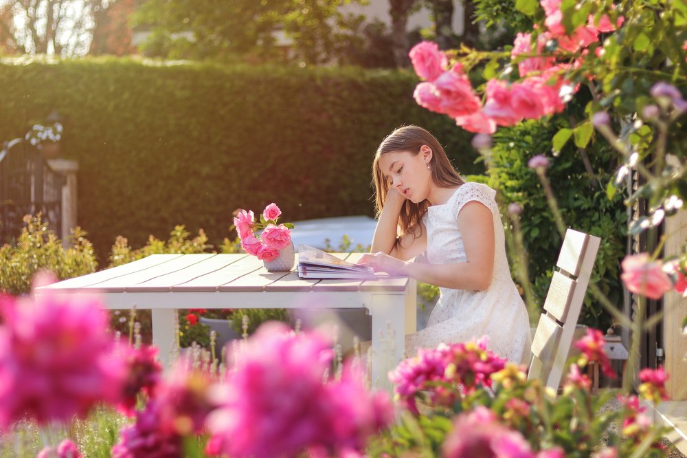 Girl reading a book in the garden