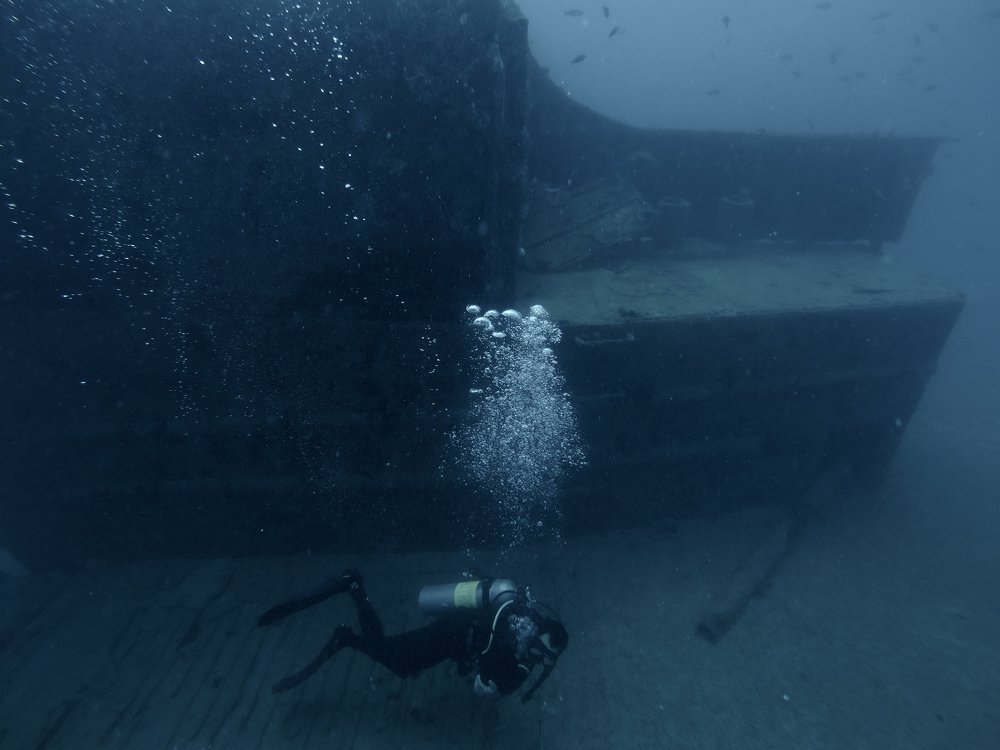 Diver exploring the exterior of the wreck