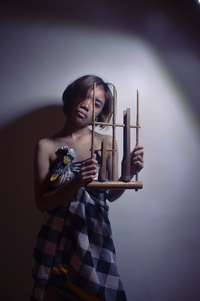 traditional woman with her favorite angklung
