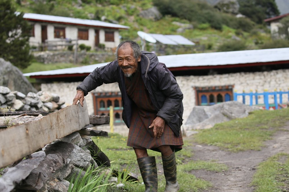 An old man fencing the field.