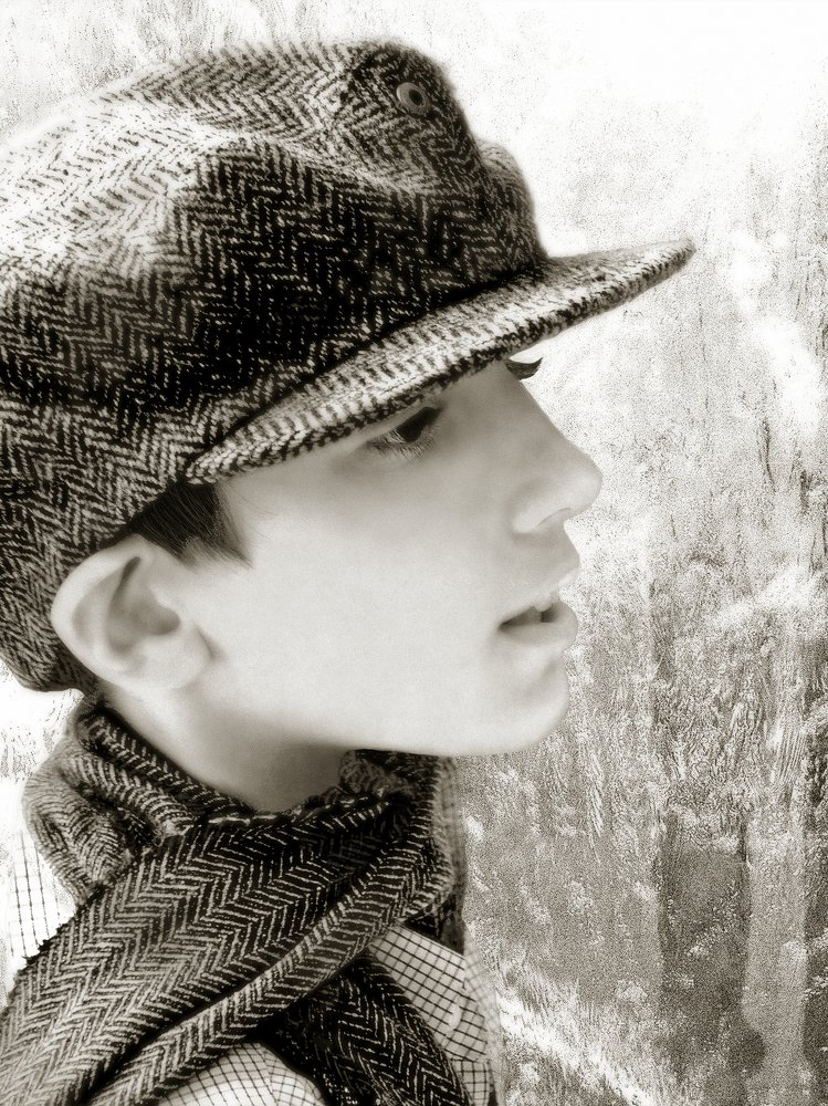 A boy wearing a scarf and cap
