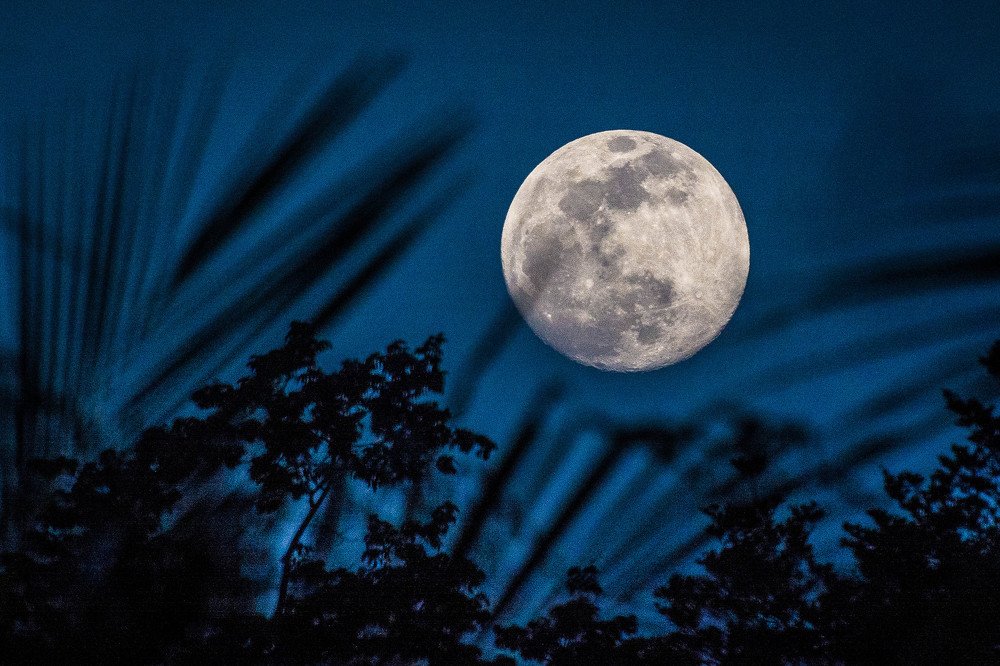 Full moon in a blue sky