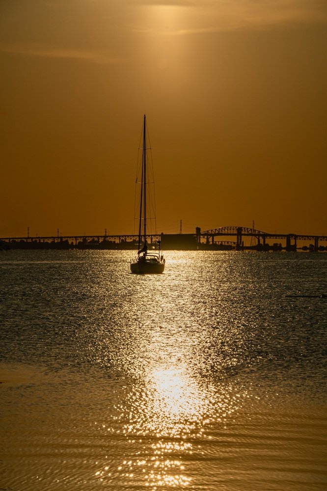 The sun shines down on a boat during early morning