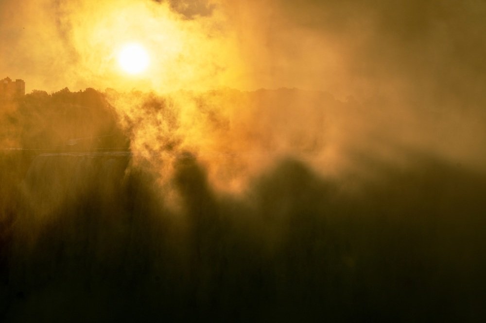 Sunrise through waterfall mist