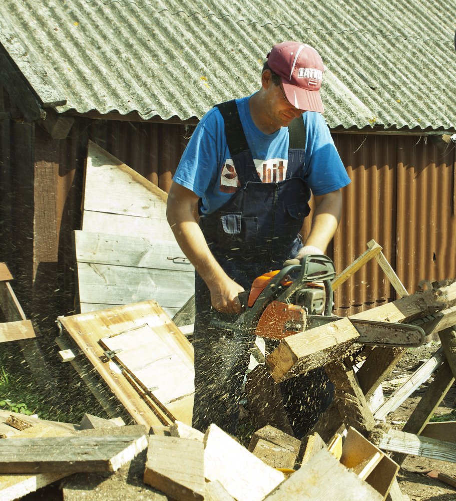 The man cuts the wood