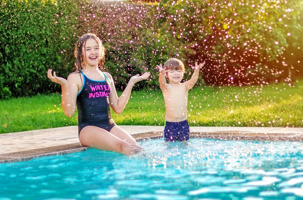 Happy siblings in the swimming pool