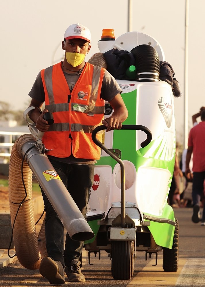 A City Corporation Worker cleaning the road