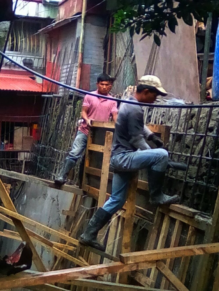 Three Road Masons Cementing Riprap Rockwalling