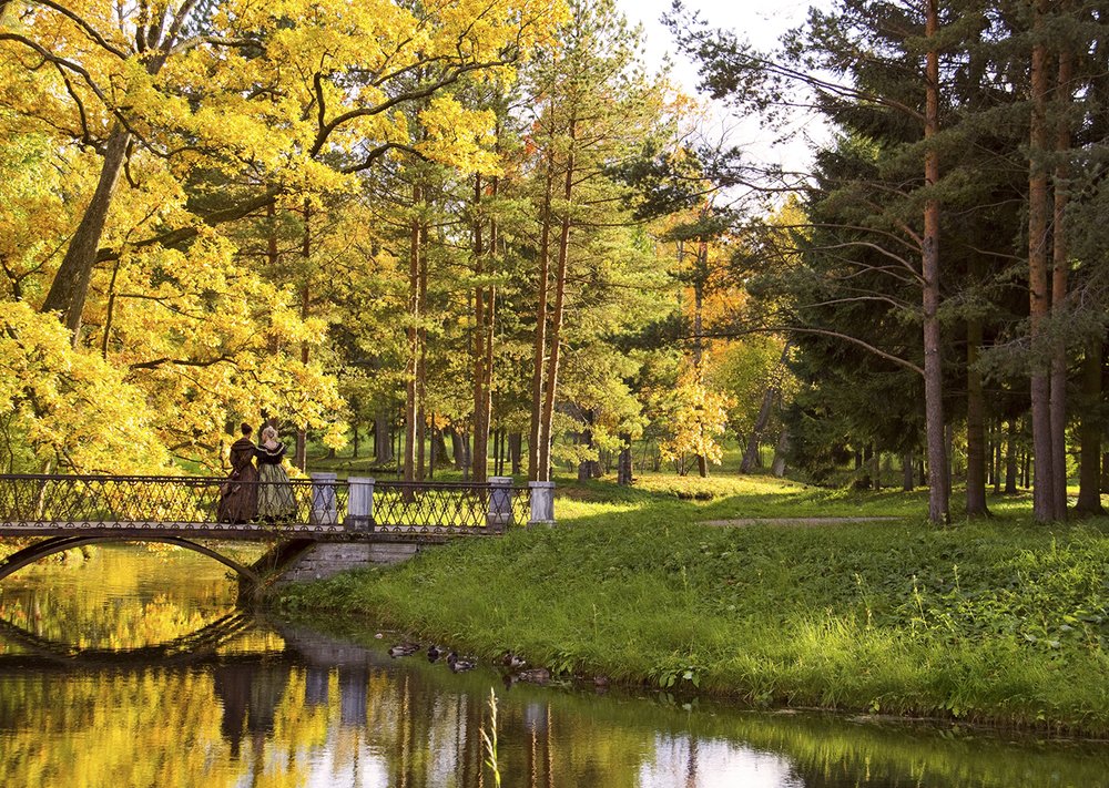 Autumn park scene with two woman in historic dresses