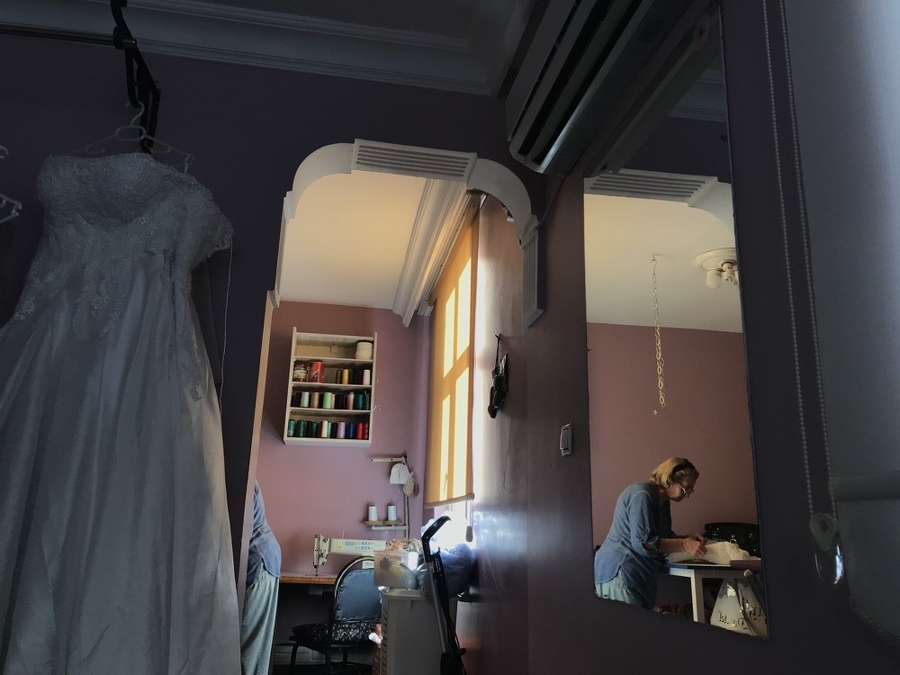 old tailor in yellow room