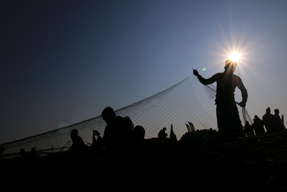 FISHERMAN WITH MORNING SUN