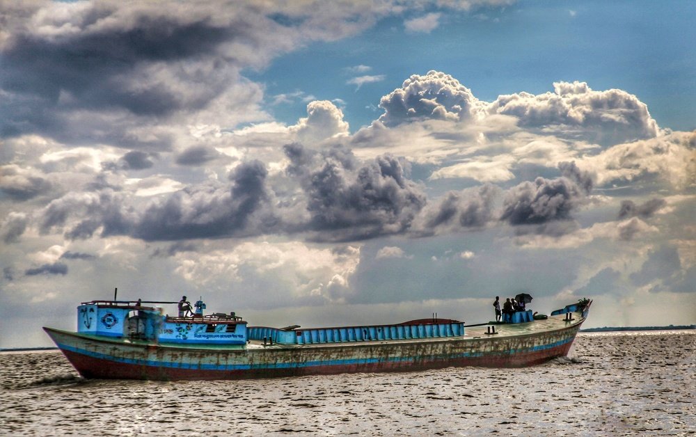 A boat and a boat mans daily life in a river