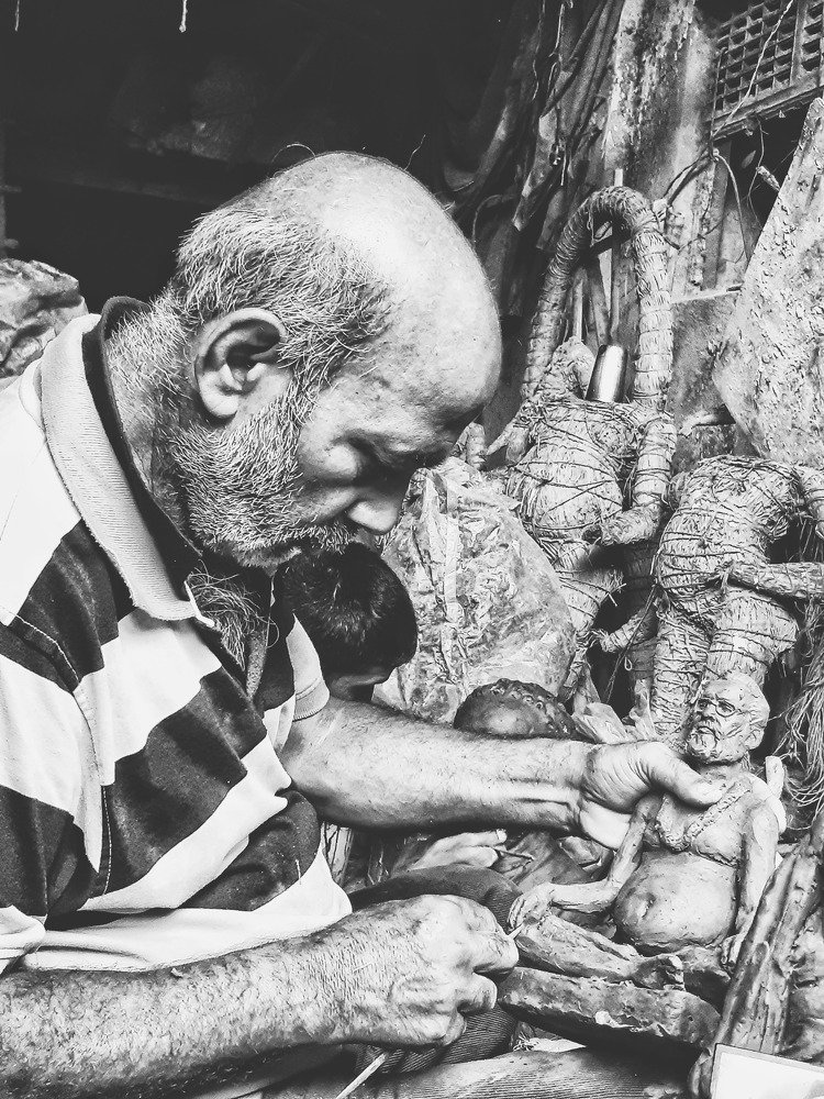 The Artist Making The Mud Sculpture Of Himself